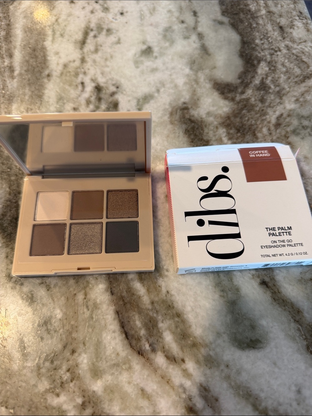 The Palm Pallet-coffee in hand